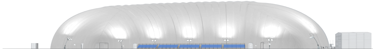 Interior of a large white inflatable sports dome with blue bleachers and lighting fixtures along the walls.